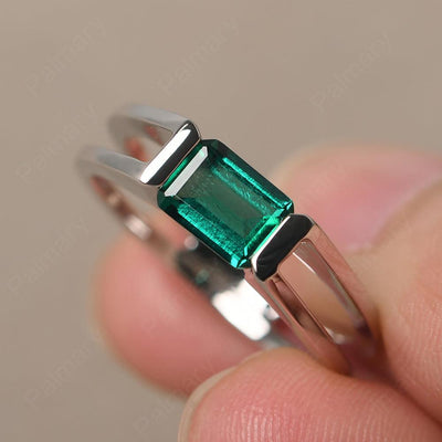 East West Emerald Cut Emerald Solitaire Ring - Palmary