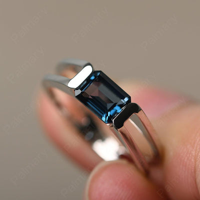 East West Emerald Cut London Blue Topaz Solitaire Ring - Palmary