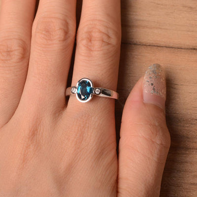 Oval London Blue Topaz Bezel Engagement Rings - Palmary